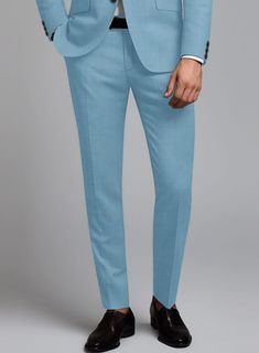 Give yourself a modish look with our Marco Stretch Pastel Blue Wool Suit. Meticulously fashioned from a wool blend, it boasts a delightful amount of stretch for that added touch of freedom. The pastel blue hue with a solid pattern offers a refreshing twist without veering into overly bold territory. Whether you're turning heads at a social gathering or aiming to infuse a dash of personality into your everyday style, this suit effortlessly takes center stage as your go-to chic upgrade.   Look Inc Fitted Wool Suit In Solid Color, Fitted Solid Wool Suit, Spring Wool Suits With Welt Pockets, Tailored Blue Wool Suit, Blue Wool Suits For Workwear, Blue Wool Suits For Work, Formal Blue Wool Bottoms, Elegant Blue Wool Bottoms, Tailored Blue Wool Bottoms