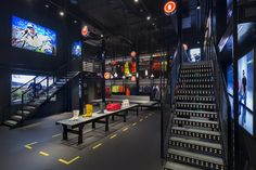 the inside of a sports shop with stairs and tables