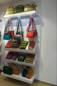 a white shelf filled with purses and handbags