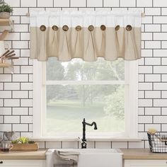 a kitchen sink under a window next to a counter