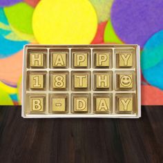 a happy 18th birthday chocolate box with the words happy 18th birthday spelled in small blocks