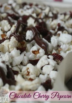 chocolate cherry popcorn with white and dark chocolate drizzled on top in a pan