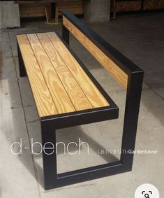 a wooden bench sitting on top of a cement floor