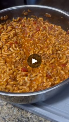 a pot full of macaroni and cheese sitting on top of a stovetop