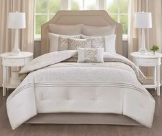 a bed with white sheets and pillows on it's headboard in front of a white background