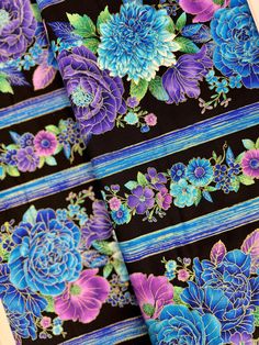 blue and purple flowers on black fabric