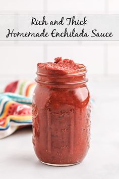 a jar filled with homemade enchilada sauce on top of a white counter