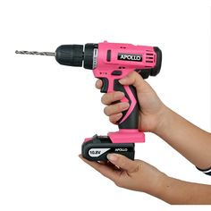 a pink cordless driller being held by someone's hand