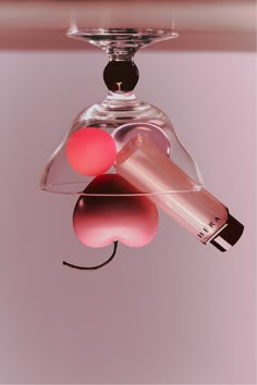 an object is suspended in the air with pink and red shapes on it's body