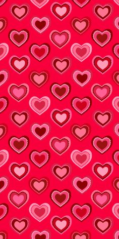 many hearts are arranged on a pink background