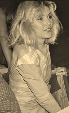 a black and white photo of a woman sitting on a couch