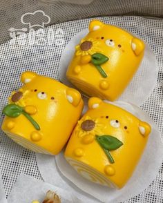 three yellow cakes decorated like animals with green leaves