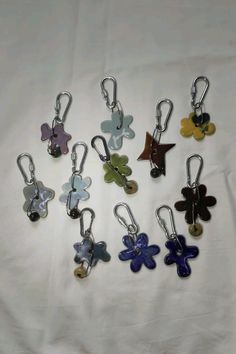 many different colored key chains on a white sheet