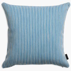 a blue and white striped pillow on a white background