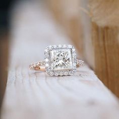 a diamond ring sitting on top of a wooden bench