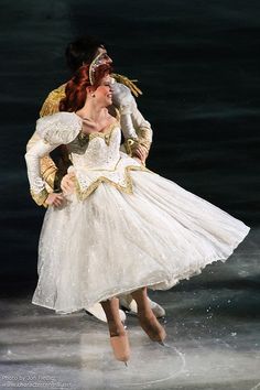 a woman in a white dress is dancing