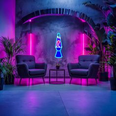 two chairs and a table in front of a wall with neon lights on it's sides