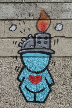 graffiti on the side of a building depicting a blue man with a hat and red heart