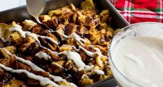 a pan filled with food next to a glass of milk