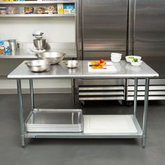 a stainless steel kitchen island with two bowls on it