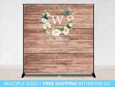 a wooden backdrop with flowers and the letter w on it