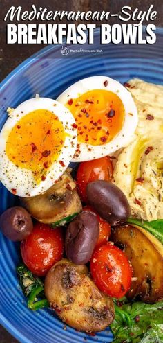 a blue plate topped with eggs and vegetables