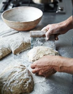 a person is kneading dough on a table