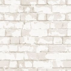 a brick wall with white paint on it