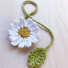 a crocheted flower is attached to a string