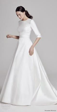 a woman in a white wedding dress is posing for the camera with her hand on her hip