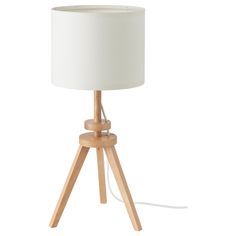 a wooden tripod table lamp with a white shade