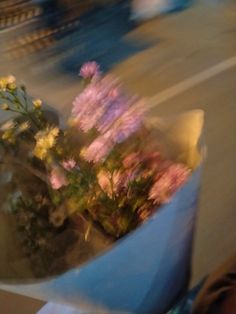 some flowers are sitting in a blue vase