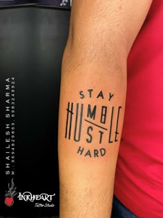 a man with a tattoo on his arm that says stay humble, hustle hard