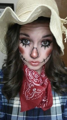 a woman with painted face and nose wearing a cowboy hat