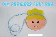 a princess felt bag with a blue ribbon around it and a smiling face on the front