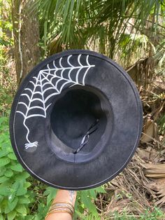 "Look spooktacular this season with our Spider Nights handpainted hat! Perfect to wear casually or for a fun occasion.  THIS IS A LARGER HAT INSIDE,  Head width is 8\" x 6\" Just a heads up😉 Made of vegan suede. Dimensions: 14\" wide x 15.5\" long. 3.5 inch brim Adjustable strap inside inner band for the better fit." Black Fedora Halloween Costume Hat, Black Fedora For Halloween, Witchy Black Costume Hats And Headpieces For Fall, Witchy Black Costume Hat For Fall, Whimsical Black Halloween Hat, Whimsical Black Hat For Festival, Whimsical Black Brimmed Hat, Witchy Wide Brim Hat For Fall, Witchy Costume Hats With Curved Brim For Fall