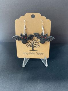 halloween earrings with bats hanging from them