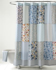 the shower curtain is made up of many different colors and patterns, including blue flowers