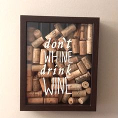 a framed wine cork art with the words don't whine drink wine