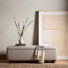 a living room with a couch, rug and potted plant