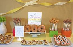 a table topped with donuts and other desserts