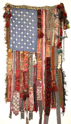 an american flag made out of many different types of fabrics and ties hanging on a wall