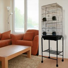 a living room with a couch, coffee table and birdcage