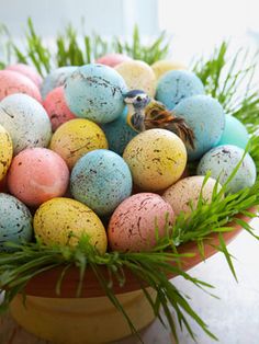 a basket filled with lots of different colored eggs