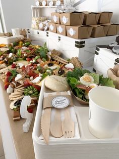 a table filled with lots of different types of food and utensils on it