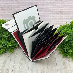 several folders stacked on top of each other in front of a brick wall