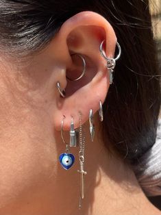 a close up of a person with ear piercings and an eye on the inside of their ear