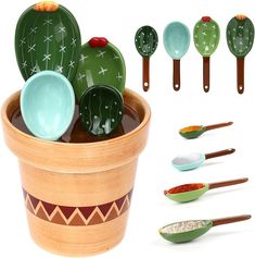 a pot filled with lots of different colored spoons next to some cactus shaped dishes