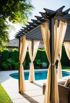 an outdoor gazebo with curtains over it and a pool in the backgroud