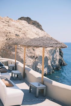 an outdoor seating area overlooking the ocean